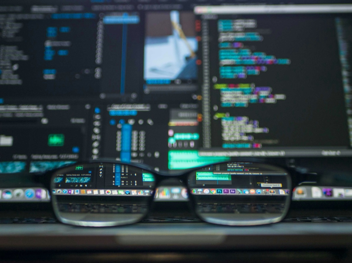Eyeglasses bringing blurred lines of code into sharp focus